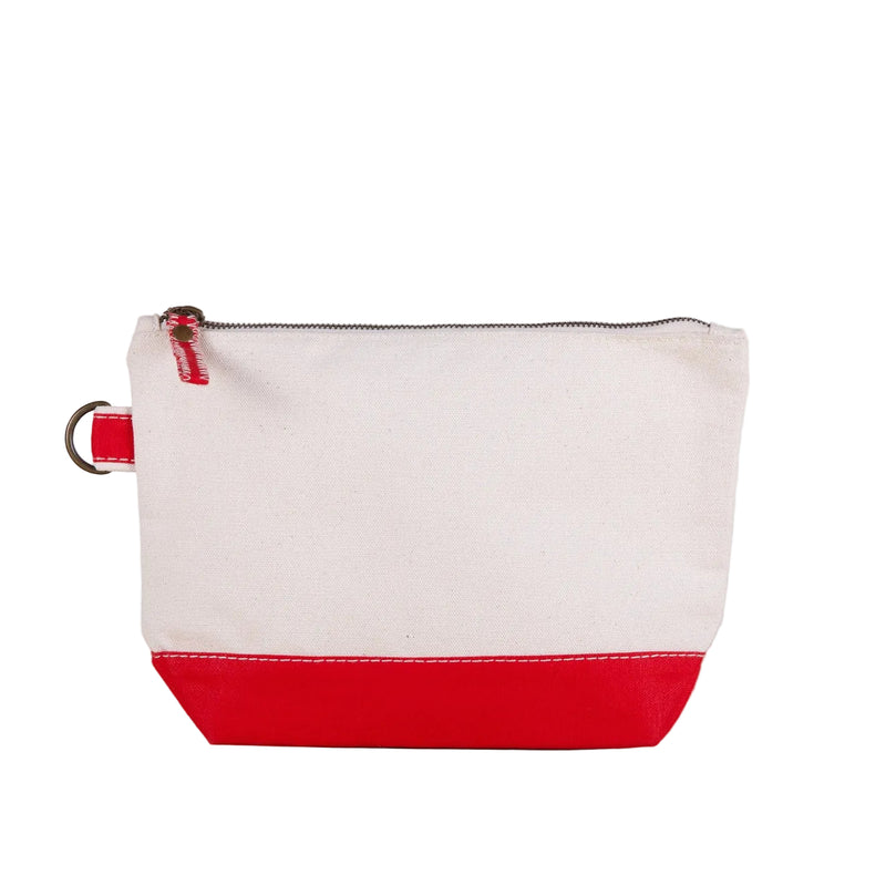 White and red pouch on a wooden surface with a light gray background