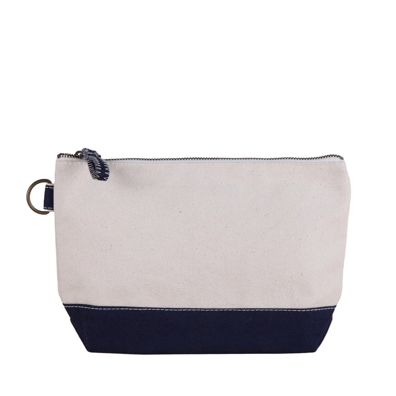 Beige and navy pouch with a zipper on a wooden surface and light gray background