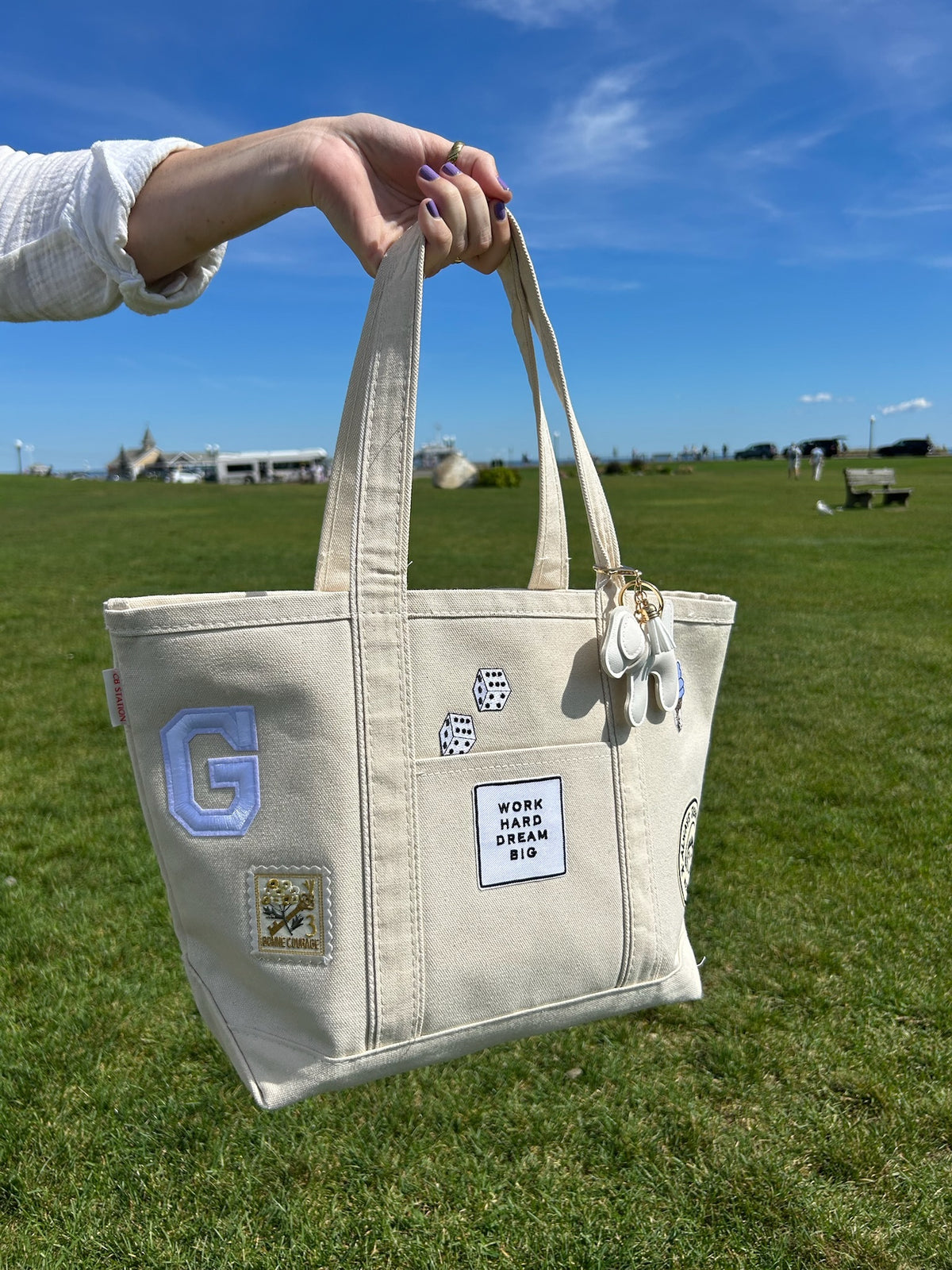 Cream tote with letter G, Work Hard Dream Big charms