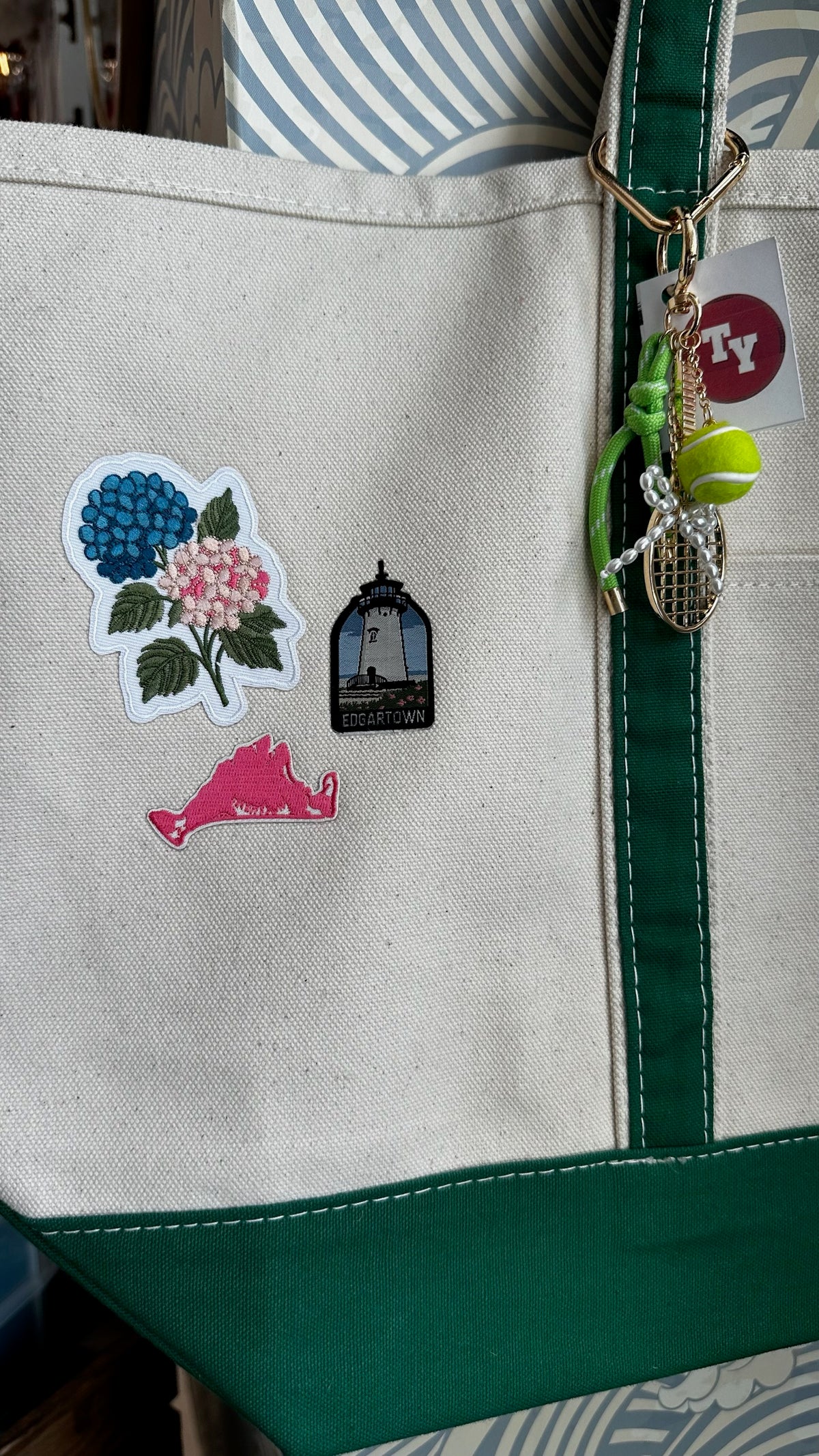 Green custom tote with Edgartown lighthouse, hydrangea, and tennis charms